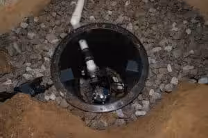 Sump pump and channel installed in a crawl space