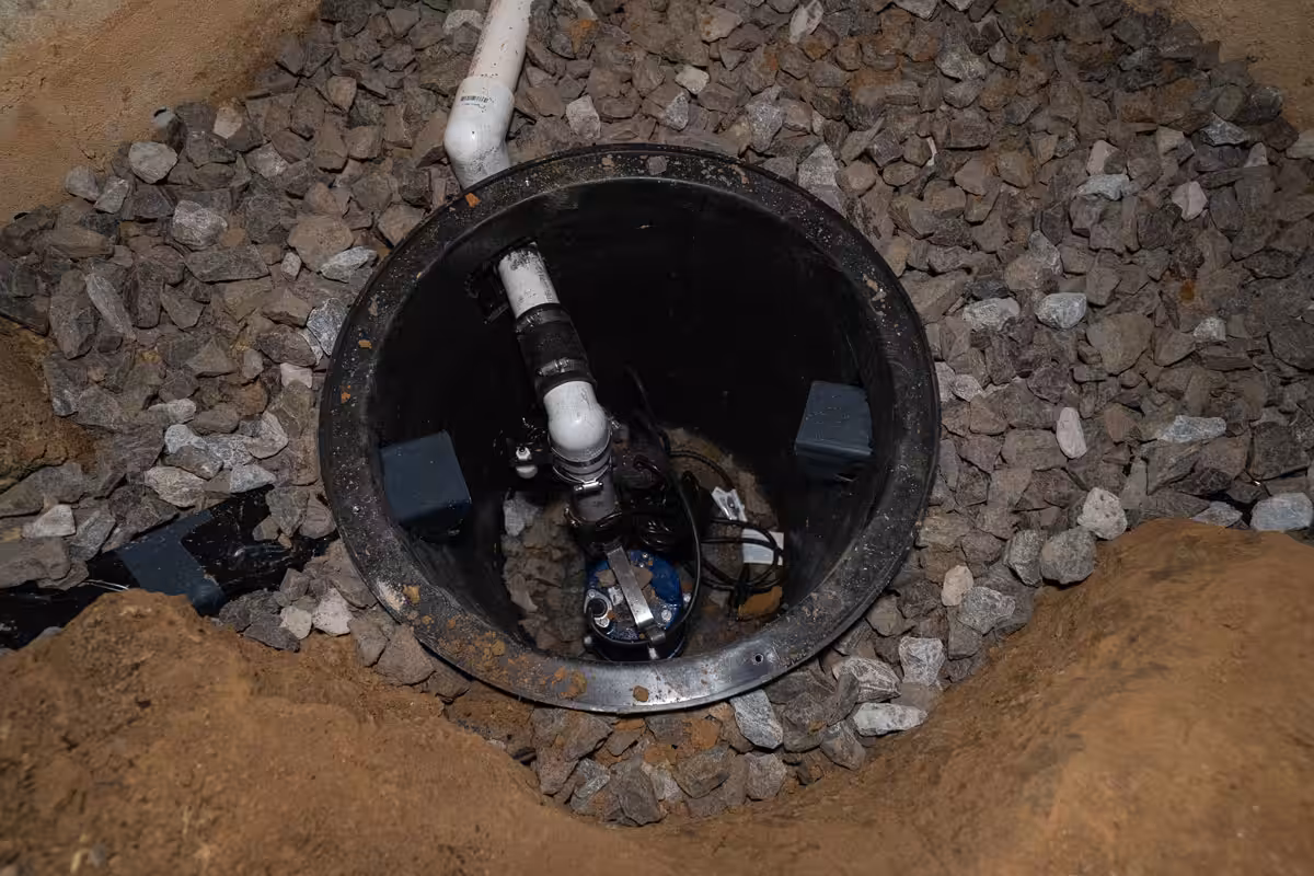 Sump pump and channel installed in a crawl space