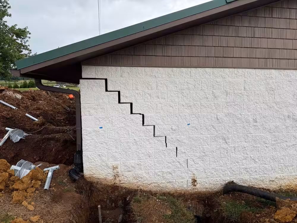 A building at a golf course with major stair-step cracking on the exterior