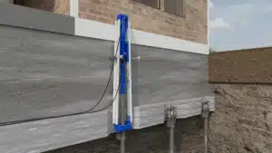 A diagram of a push pier installed on the side of a home's foundation and stuck into the ground