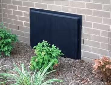 A crawl space vent cover on the side of a home